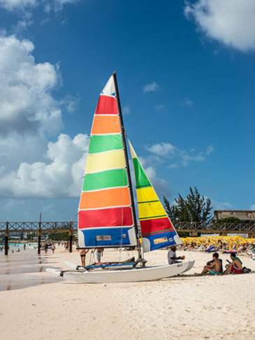 Colorful sails on a small boat on the beach in Bridgetown, Barbados